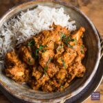 Chicken tikka masala curry in a bowl with rice.
