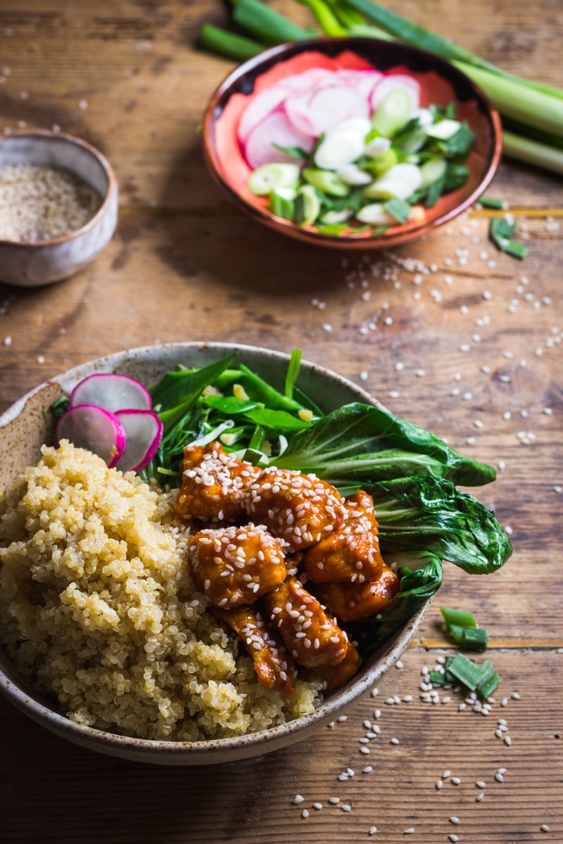sesame seed chicken with quinoa and asian green vegetables
