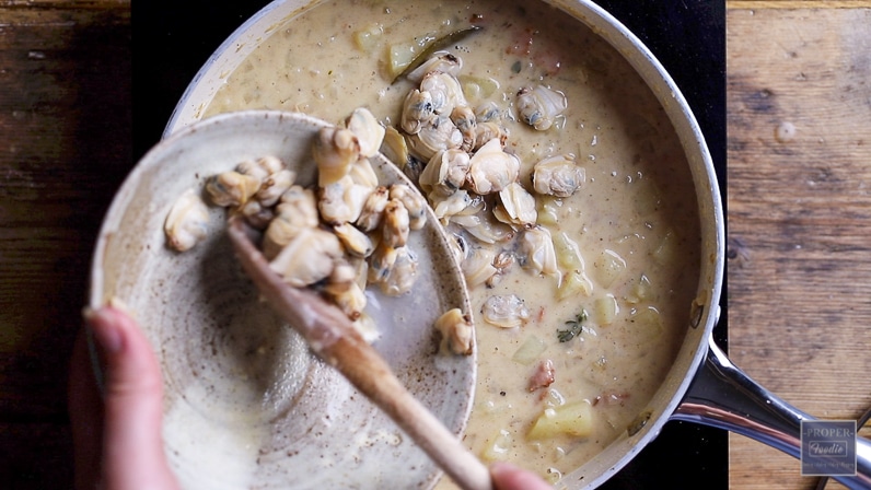 remove cooked clams from their shells and add to the chowder