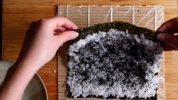 flip over rice and nori so rice is on the underside