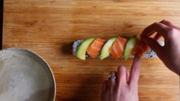 top the california roll with avovadoc and salmon to make it a dragon roll
