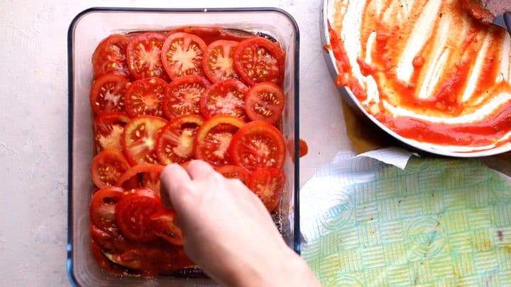 adding a final layer of sliced tomatoes