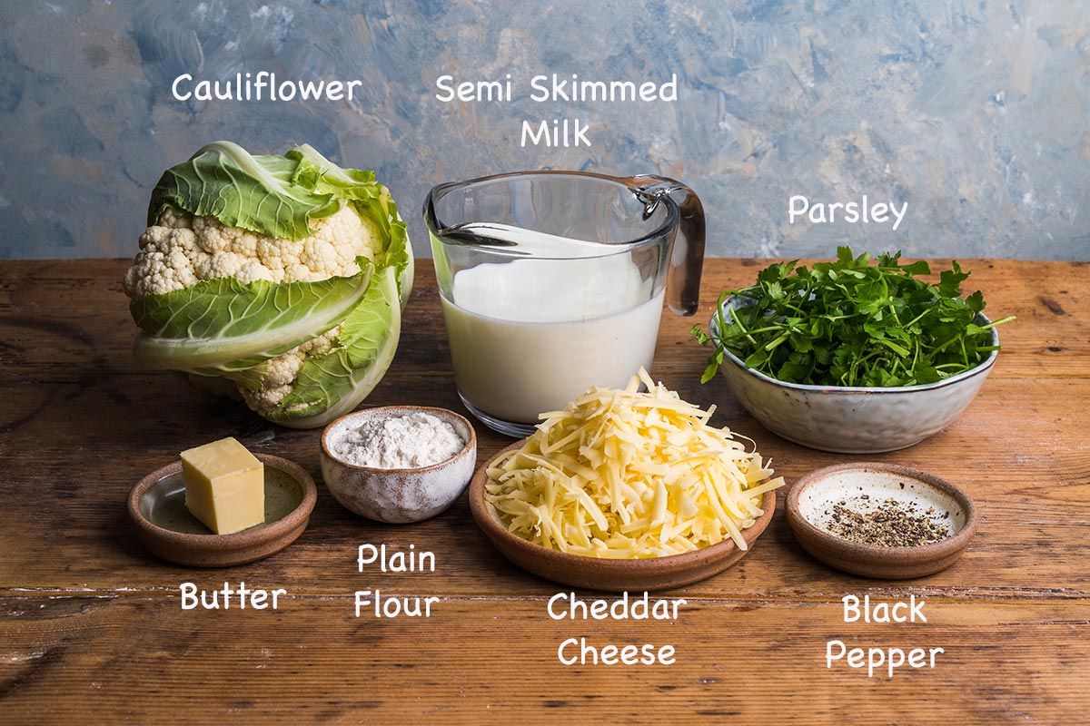 A display of the ingredients needed to make cauliflower cheese with text overlay stating each ingredients.