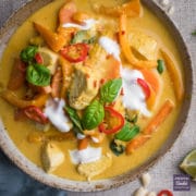 Thai Panang curry in a bowl with yogurt and fresh chillies